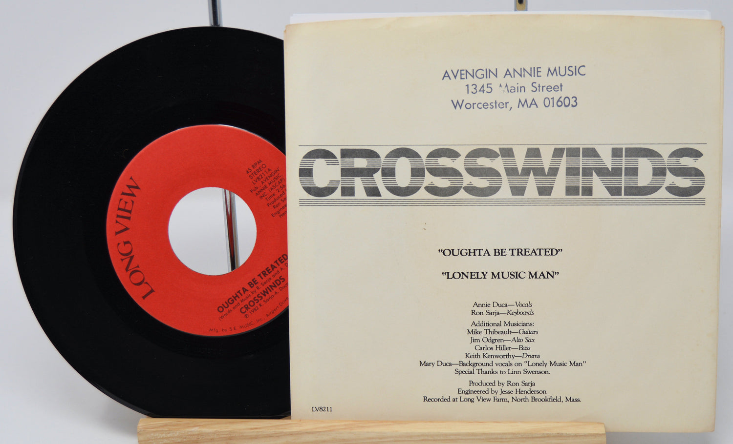 Vinyl record and its cover with 'Crosswinds' on a white background