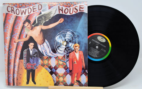 Vinyl record and cover for 'Crowded House' album on a light gray background