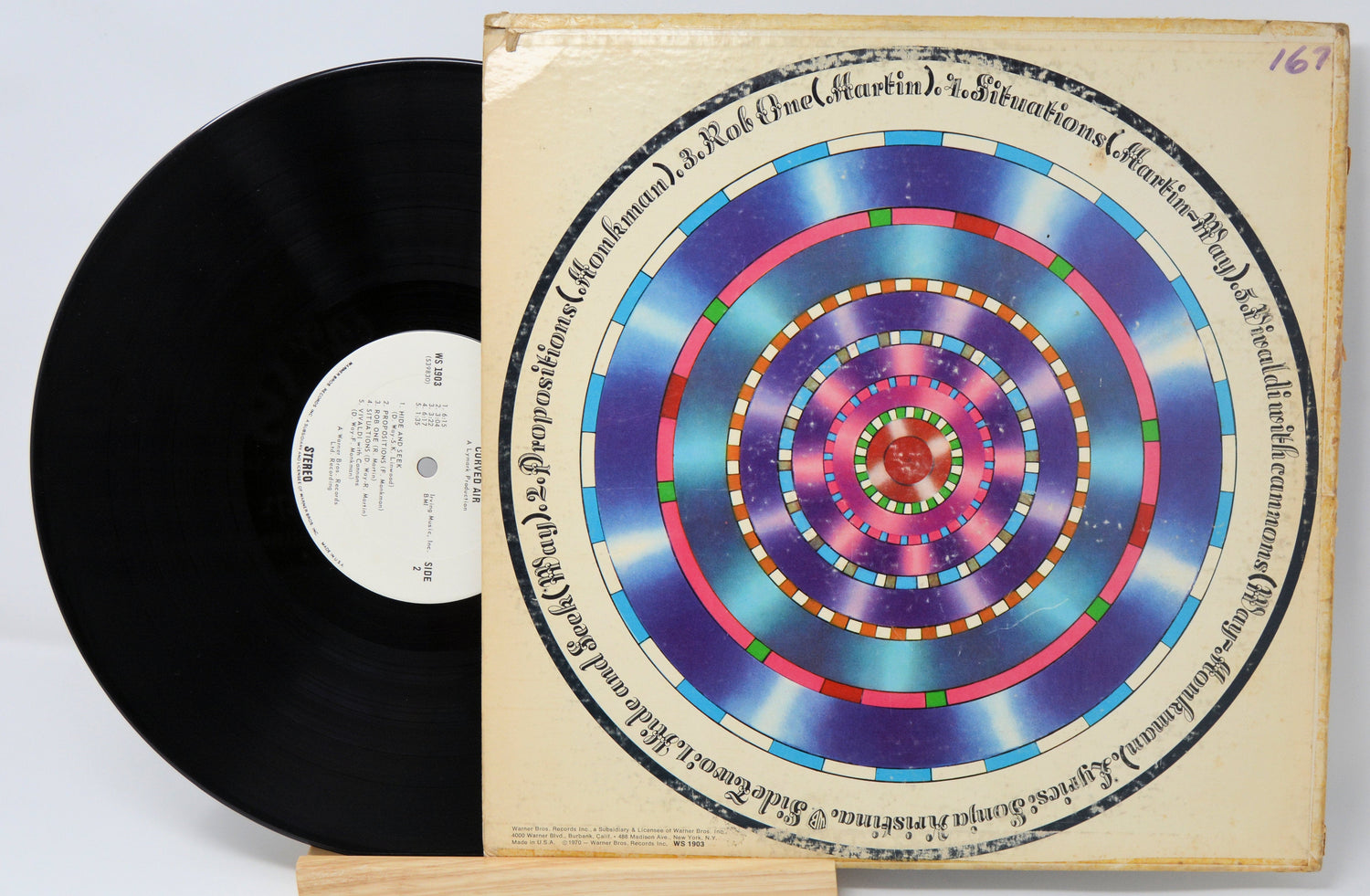 Curved Air Air Conditioning vinyl record partially removed from cover with colorful concentric circle artwork