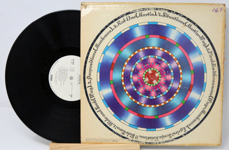 Curved Air Air Conditioning vinyl record partially removed from cover with colorful concentric circle artwork