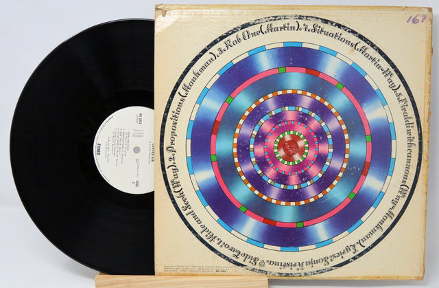 Curved Air Air Conditioning vinyl record partially removed from cover with colorful concentric circle artwork