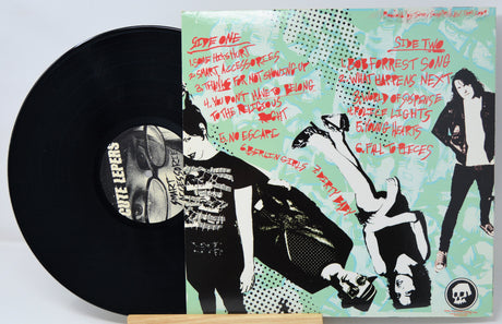 Vinyl record with a colorful cover featuring artistic illustrations and text.
