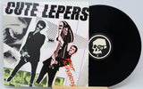Vinyl record with a colorful cover featuring band members and a black record with a skull logo.