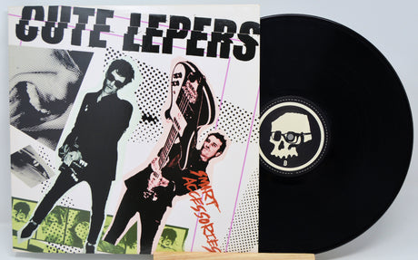 Vinyl record with a colorful cover featuring band members and a black record with a skull logo.