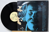 Vinyl record with a cover featuring a face and text on a white background