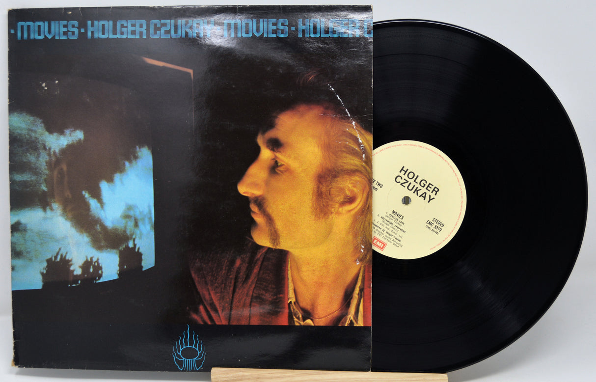 Vinyl record with cover featuring a person's profile and text 'Movies - Holger Czukay'.