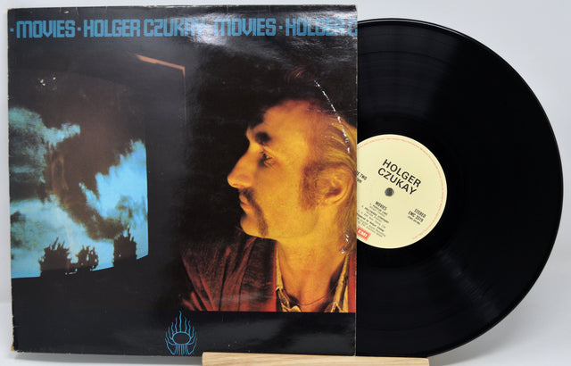 Vinyl record with cover featuring a person's profile and text 'Movies - Holger Czukay'.