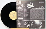 Vinyl record with cover featuring black and white images of musicians and text.