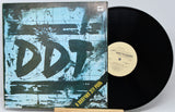 Vinyl record with a blue and black cover featuring the text 'DDT' on a white background.