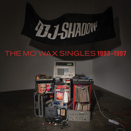 Album cover for 'The Mo'Wax Singles 1993-1997' by DJ Shadow with vinyl records and equipment.