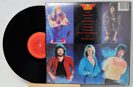 Vinyl record with colorful cover featuring a person in various poses