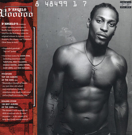 D'Angelo posing shirtless for the Voodoo album cover, showcasing his cross necklace and muscular physique