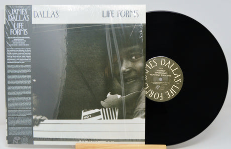Vinyl record with cover featuring a person holding a book titled 'Dallas Life Forms'.