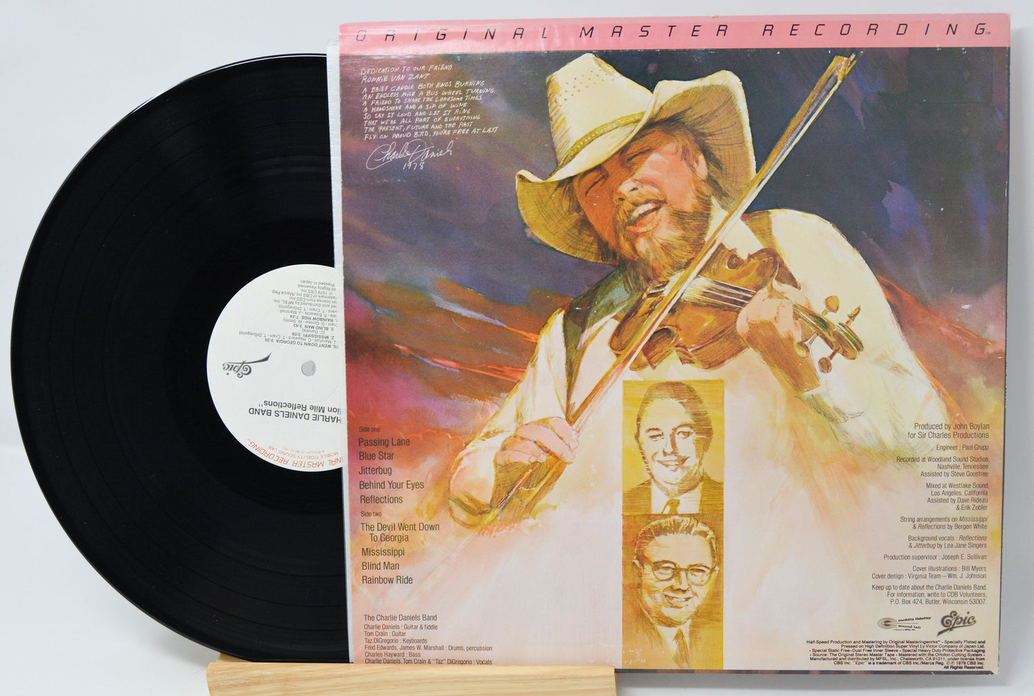 Vinyl record with cover featuring a person playing violin, on a light gray background