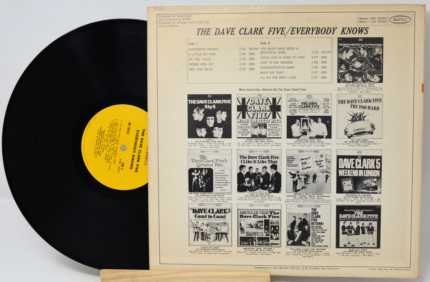 Vinyl record with yellow label and cover featuring black and white images and text.
