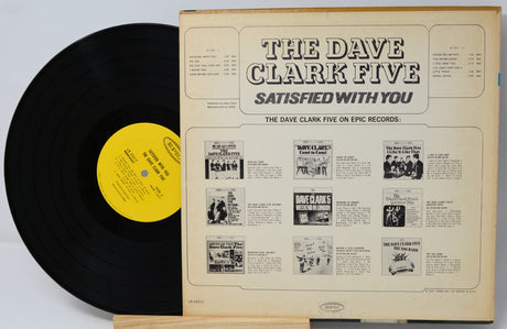 Vinyl record with yellow label and cover featuring 'The Dave Clark Five' on a light gray background