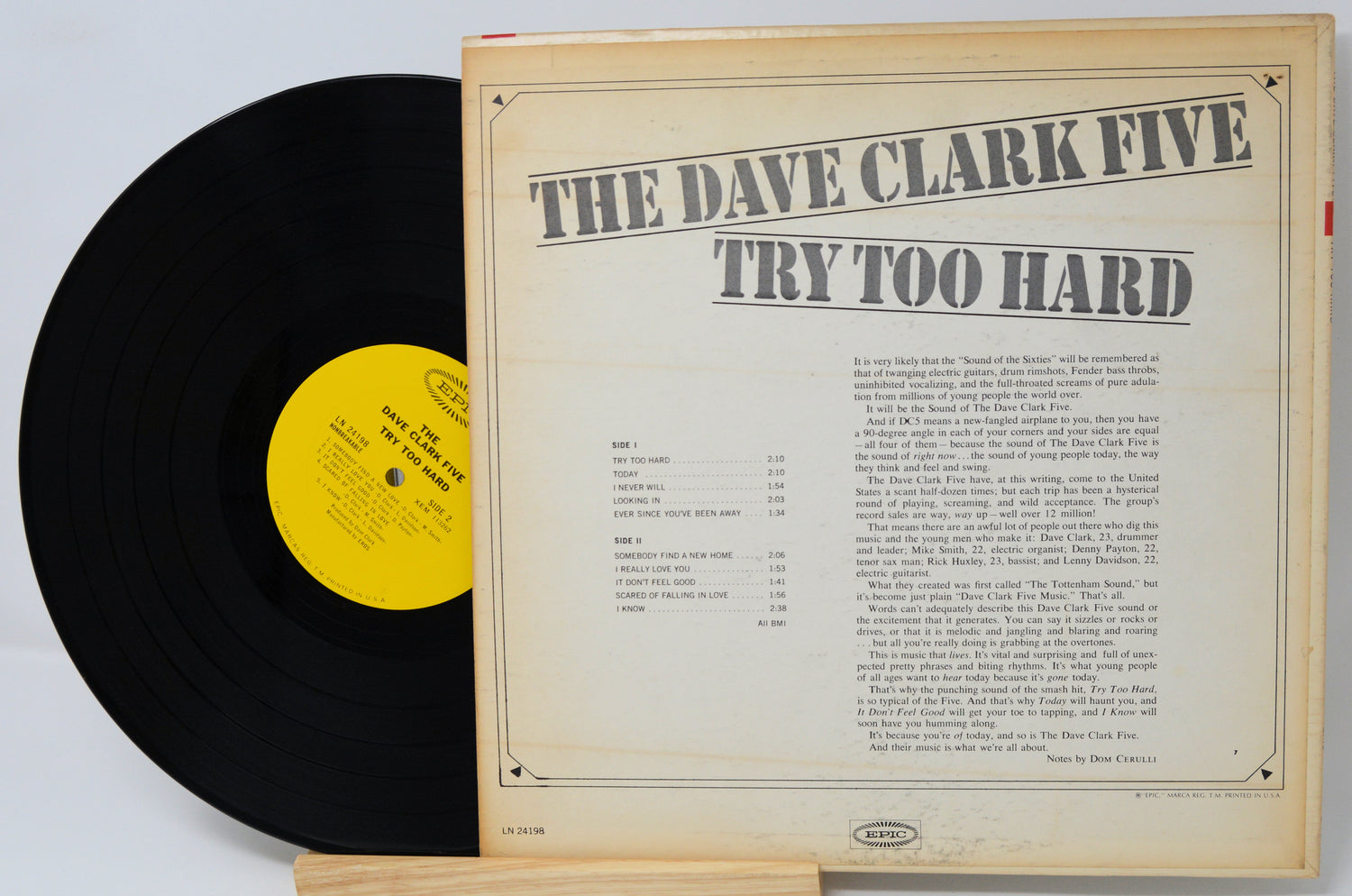 Vinyl record with 'The Dave Clark Five Try Too Hard' cover on a light gray background