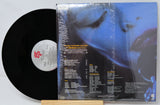 Vinyl record with cover featuring text and a blue abstract design