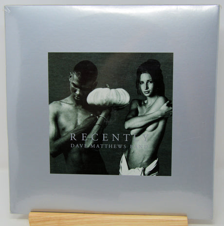 Dave Matthews Band 'Recently' vinyl record album cover, sealed in plastic shrink wrap and displayed on a wooden stand against a light gray background.