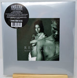 Dave Matthews and Linda 'Recently' Deluxe Vinyl Edition LP cover, sealed in its original plastic shrink wrap and standing on a light wood block. The cover is a muted gray-green with a black circular sticker on the top left.