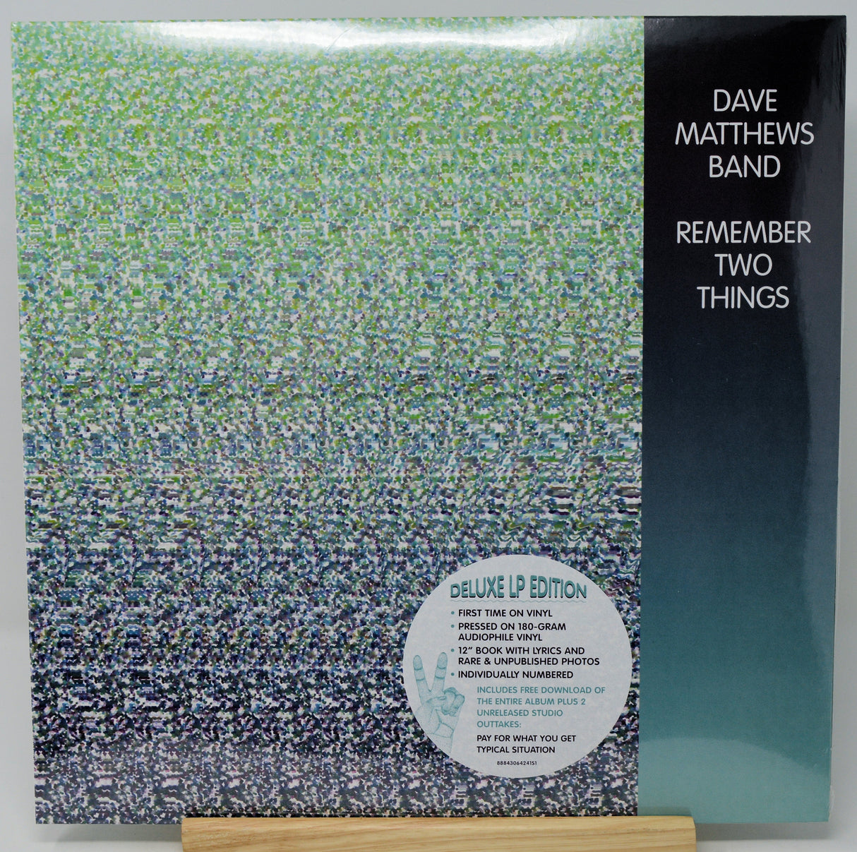 Dave Matthews Band 'Remember Two Things' deluxe LP edition vinyl record cover, showing the textured gradient artwork and a black spine band with white text, displayed on a wooden stand.