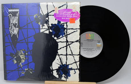 Vinyl record with cover featuring abstract design and 'EMI' label.