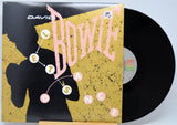 12 Inch Vinyl record with a cover featuring 'David Bowie Let's Dance' in pink text on a yellow background