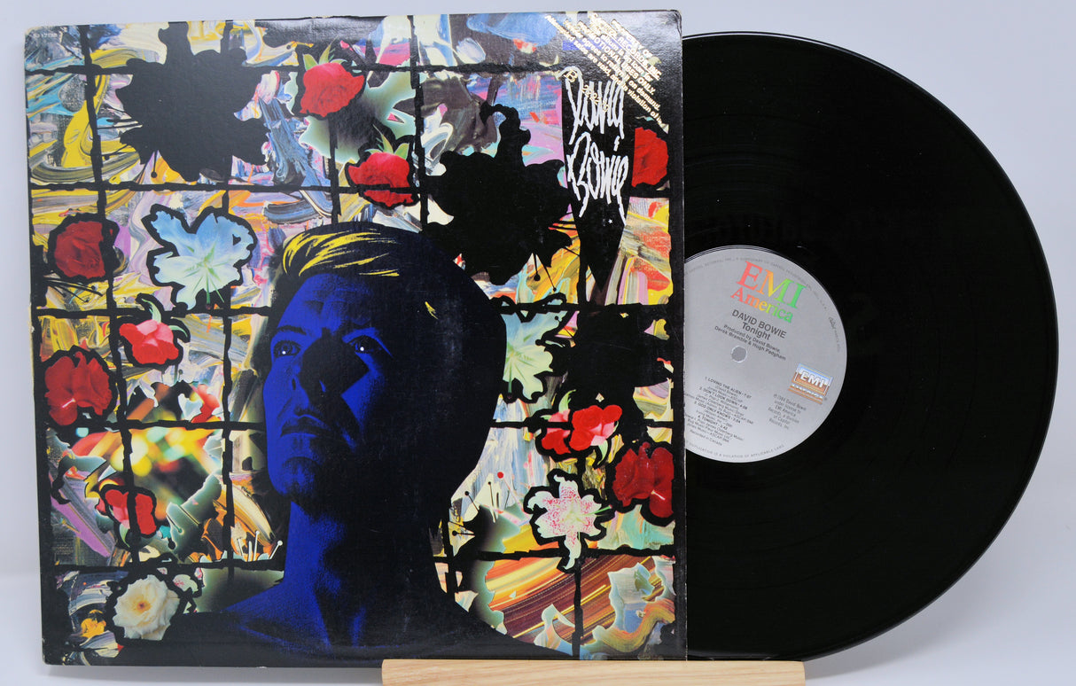 David Bowie's 'Tonight' album vinyl record with a colorful and abstract cover art featuring a stylized face.