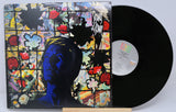 David Bowie's 'Tonight' album vinyl record with a colorful and abstract cover art featuring a stylized face.
