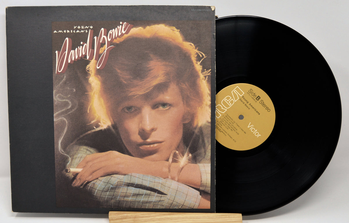 Vinyl record with cover featuring a portrait of a person, on a white background