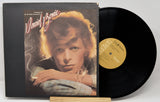 Vinyl record with cover featuring a portrait of a person, on a white background