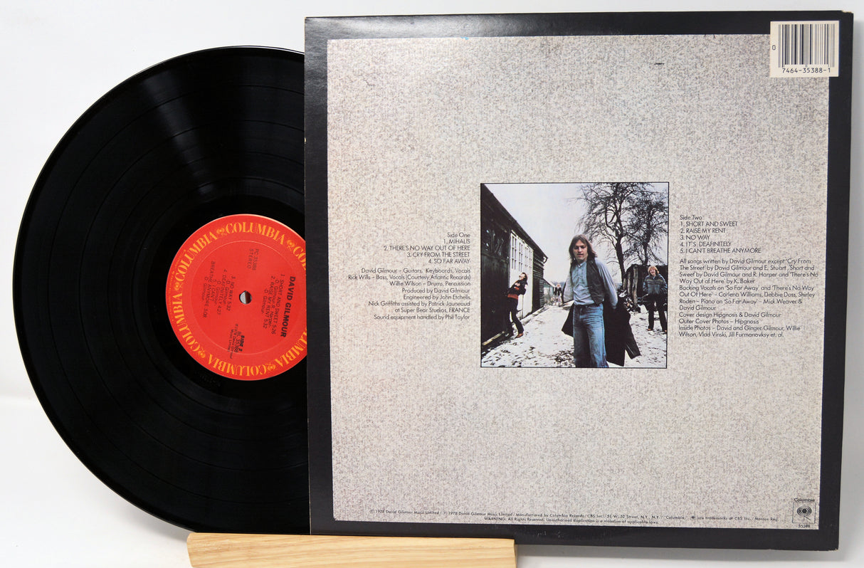 Vinyl record with cover featuring a black and white photo and text on a light gray background