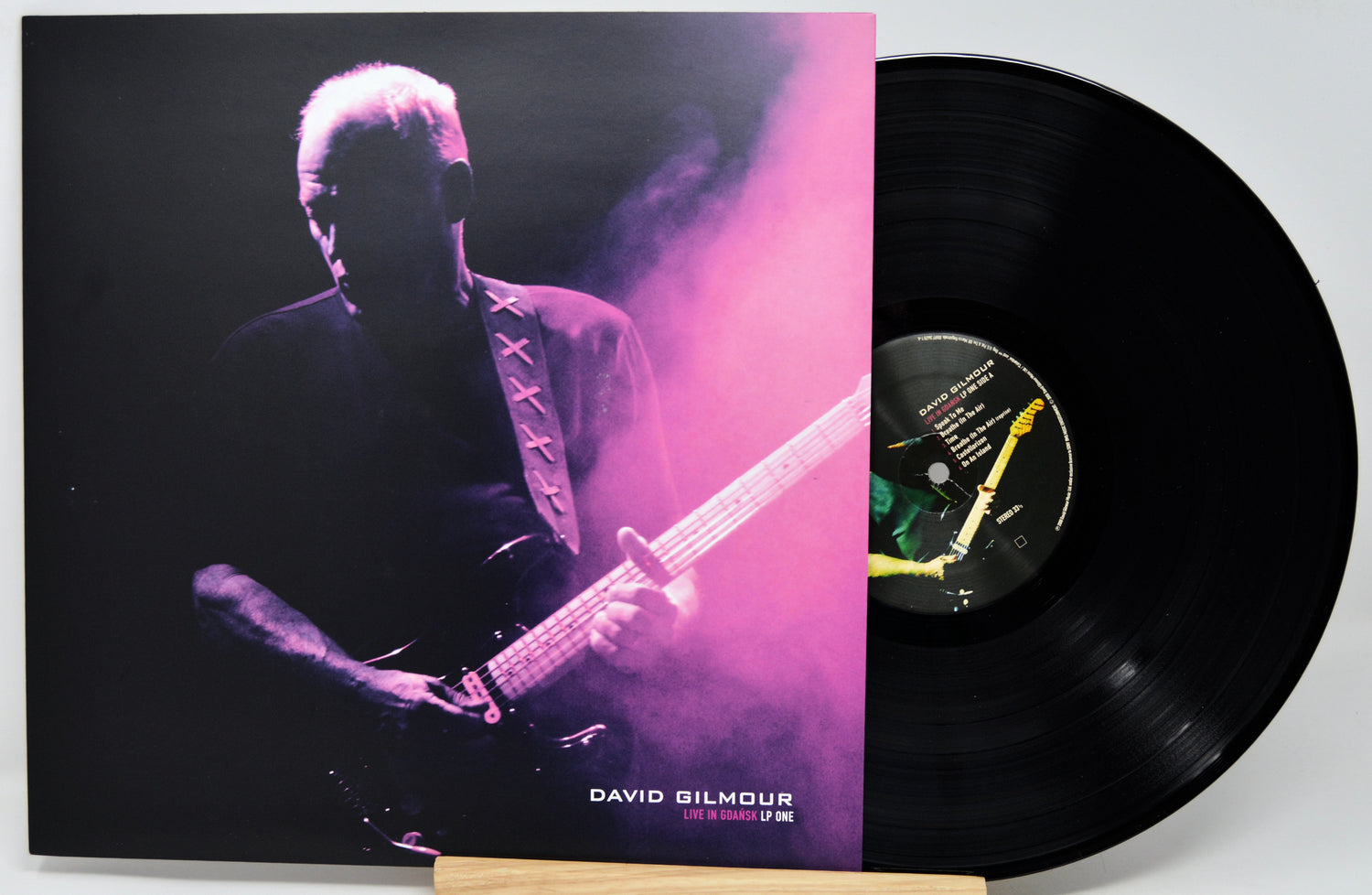 David Gilmour 'Live in London LP One' vinyl record with its illustrated album cover sleeve and a black vinyl record partially visible behind it.