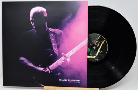 David Gilmour 'Live in London LP One' vinyl record with its illustrated album cover sleeve and a black vinyl record partially visible behind it.