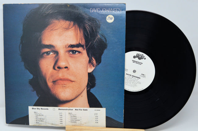 Vinyl record with cover featuring a person against a blue background