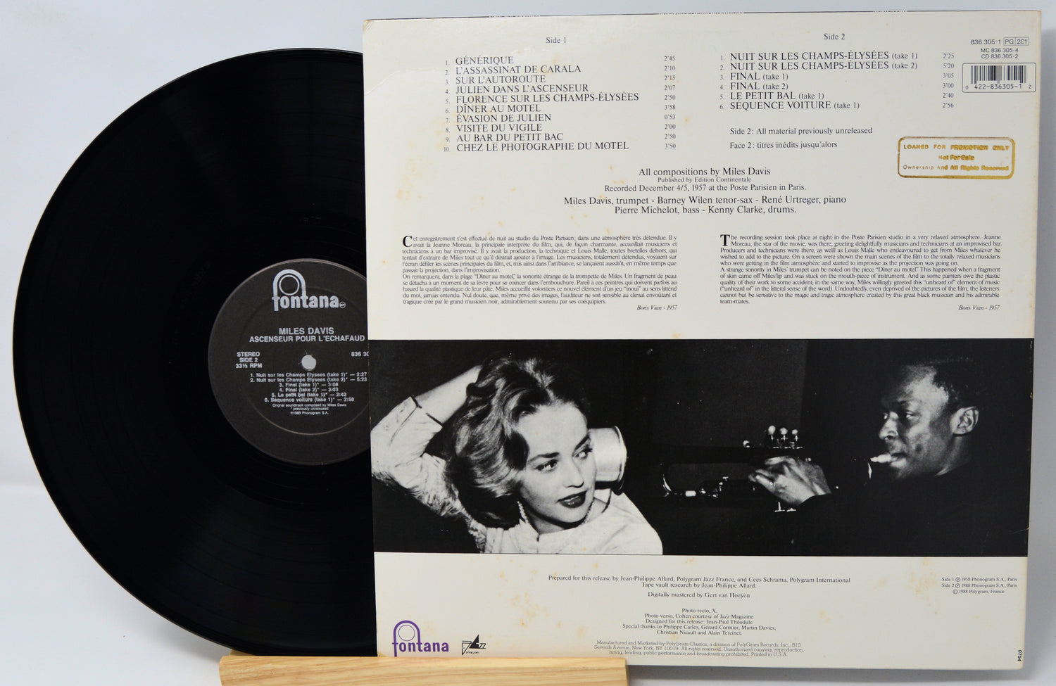 Vinyl record with cover featuring a black and white image of a woman and a man, with text on a light gray background.