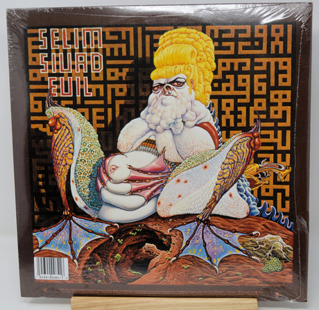 Vinyl record cover with a fantasy design featuring a bearded figure and winged creatures, with a patterned background.