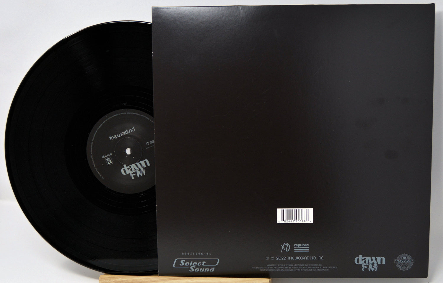 Back cover and vinyl of The Weeknd's Dawn FM album showing tracklist and label