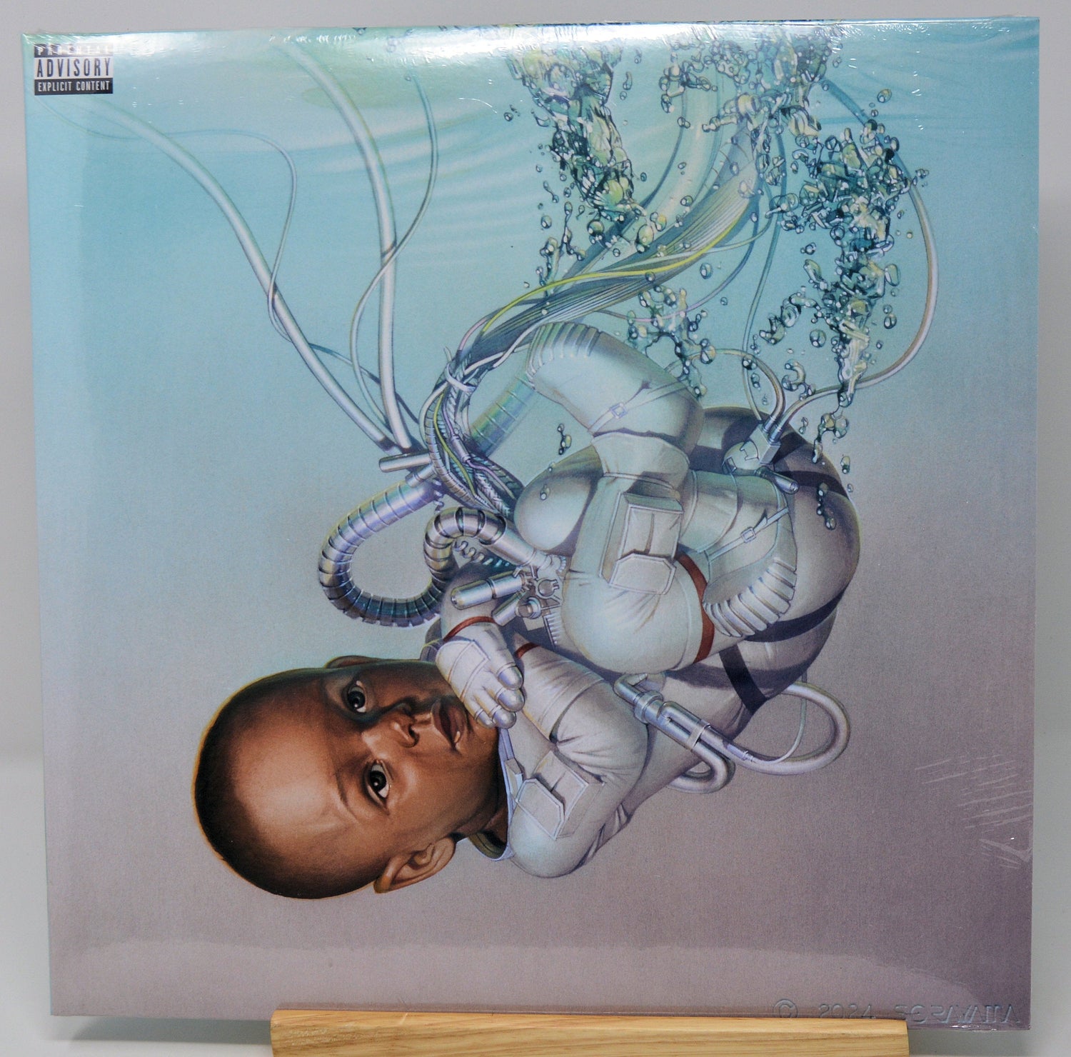 Futuristic artwork of a baby in a spacesuit surrounded by tubes from The Weeknd's Dawn FM vinyl