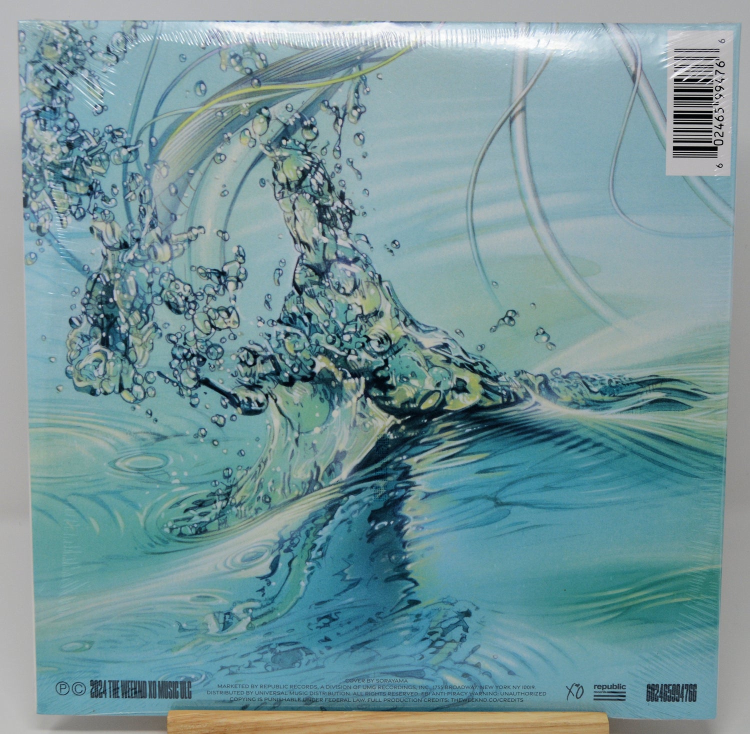 Abstract water splash with vibrant reflections from The Weeknd's Dawn FM vinyl album art