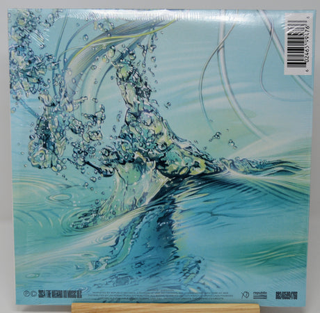 Abstract water splash with vibrant reflections from The Weeknd's Dawn FM vinyl album art