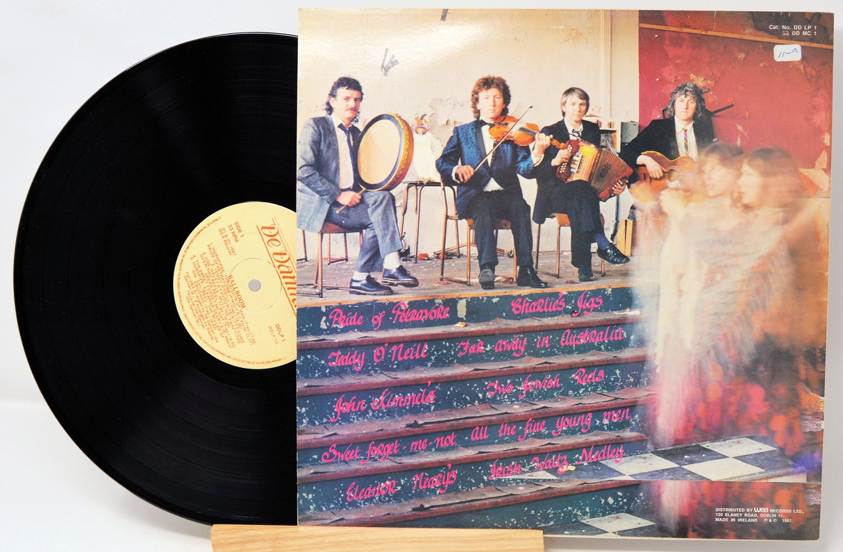 Vinyl record with a colorful cover featuring musicians and text.