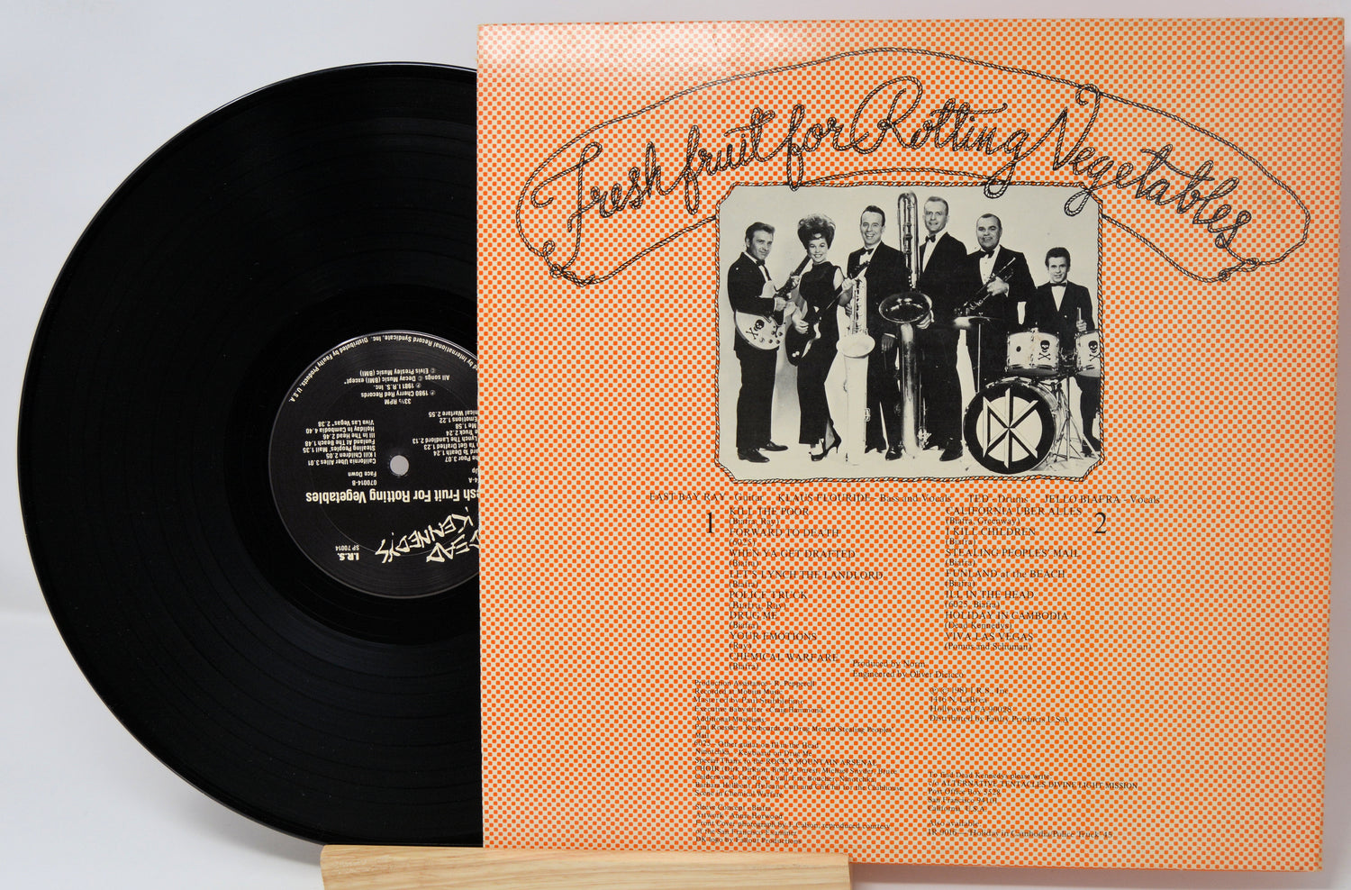 Vinyl record with a cover featuring a band and text on a light gray background