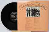 Vinyl record with a cover featuring a band and text on a light gray background