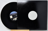 Black vinyl record with a white label on a white background