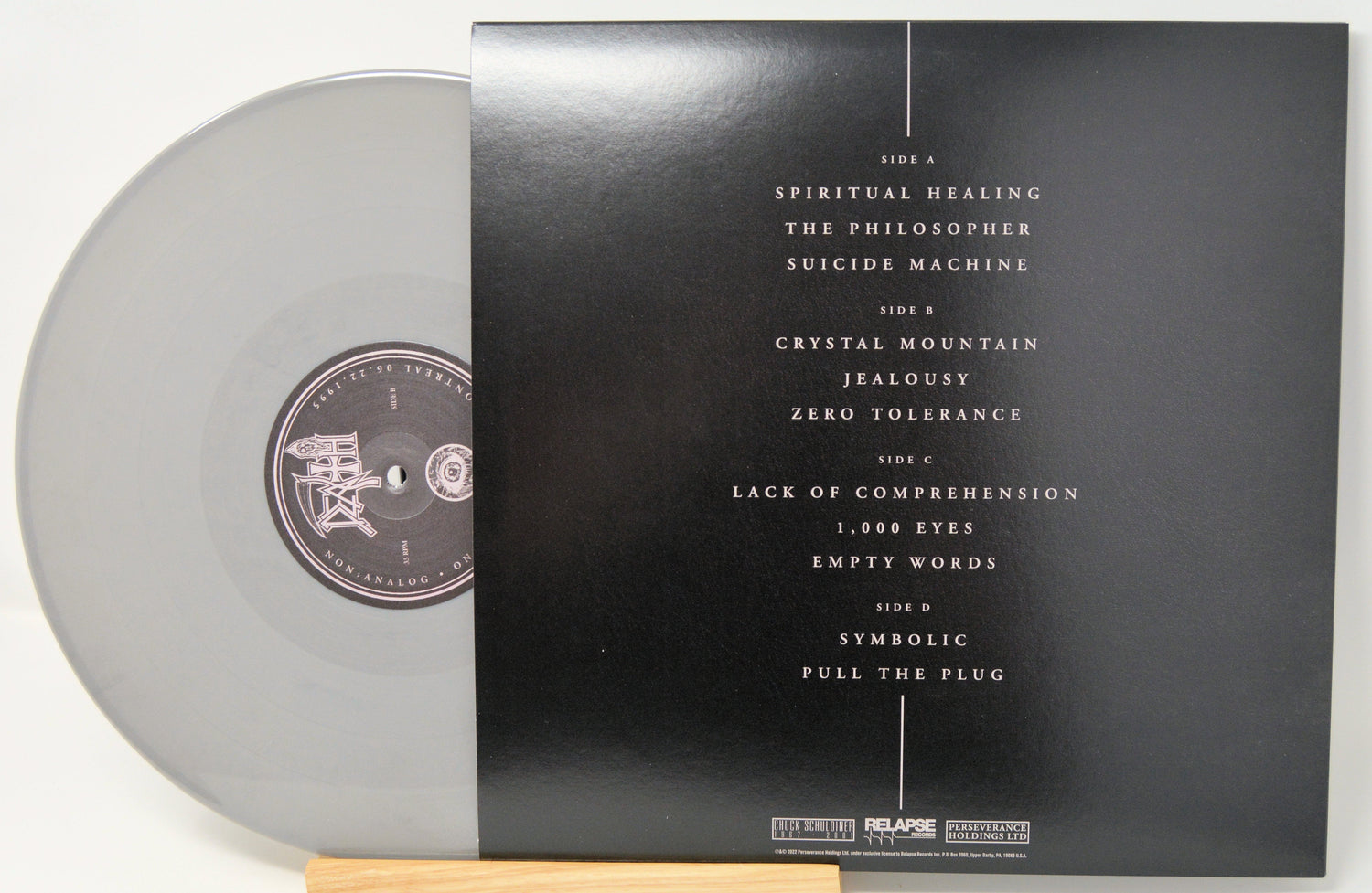 Back cover and grey vinyl record of Death – Non:Analog On:Stage Series Montreal 1995, showing tracklist