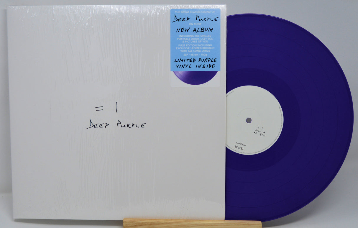 Purple vinyl record with white label and 'Deep Purple' text, held by a wooden record holder.