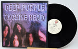 Deep Purple - Machine Head vinyl record shown with the album cover on the left and the black LP record partially pulled out on the right against a white background.