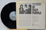 A vintage vinyl record of the band Shades of Deep Purple, showing the black LP partially pulled from the cream-colored inner sleeve with printed cover art and tracklist.
