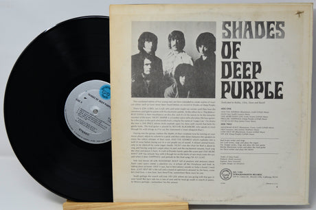 A vintage vinyl record of the band Shades of Deep Purple, showing the black LP partially pulled from the cream-colored inner sleeve with printed cover art and tracklist.